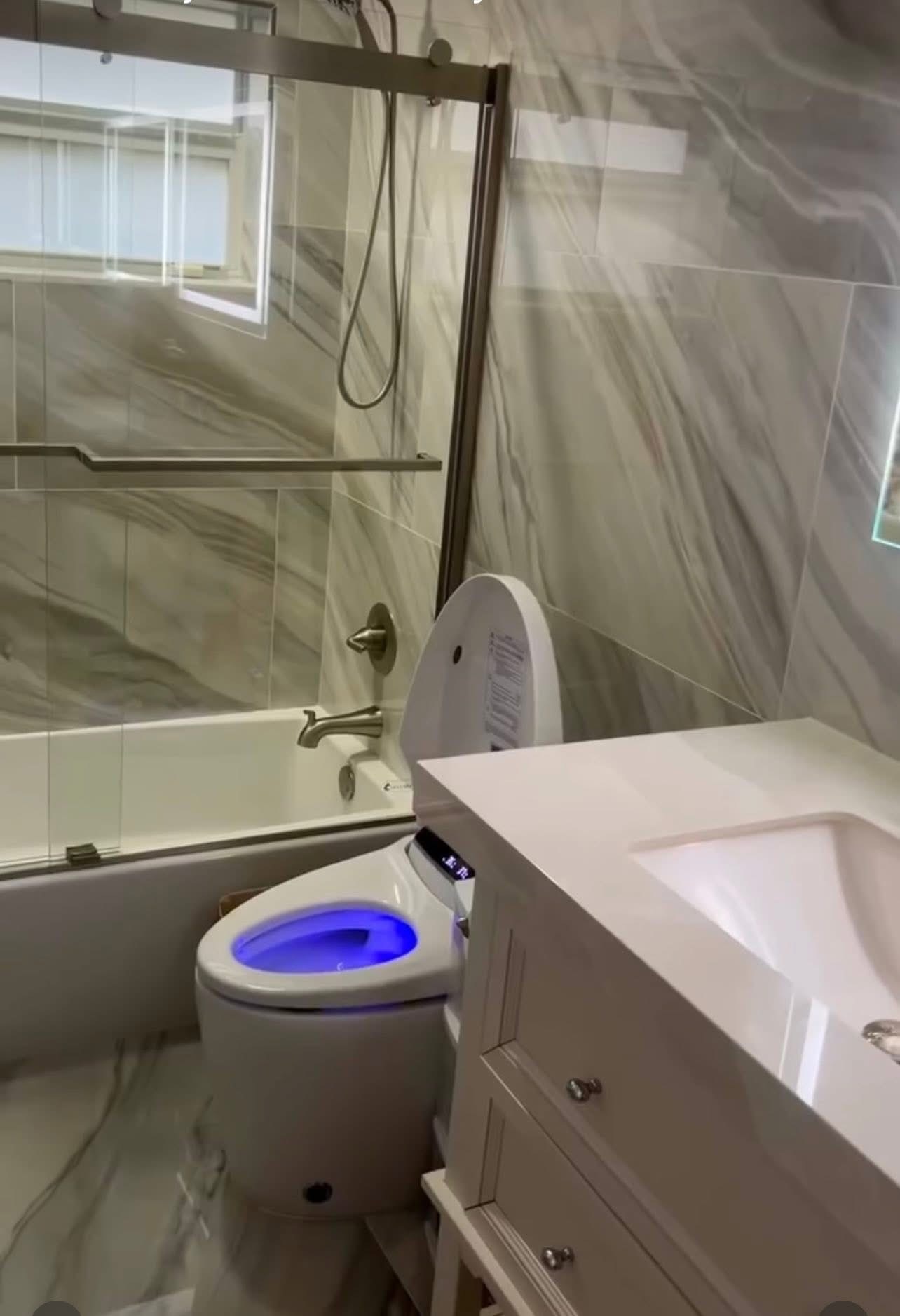 Bathroom remodel with marble tile and smart toilet