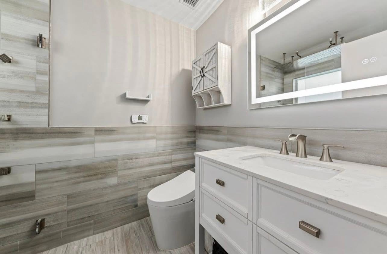 Guest bath with wood-look tile and LED mirror